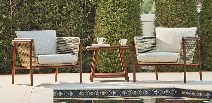 Forte collection lounge chairs and rectangular side table by a pool.