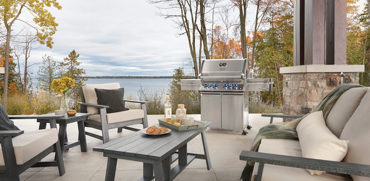 Napoleon Grill Prestige PRO 500 on a patio by a lake in the fall